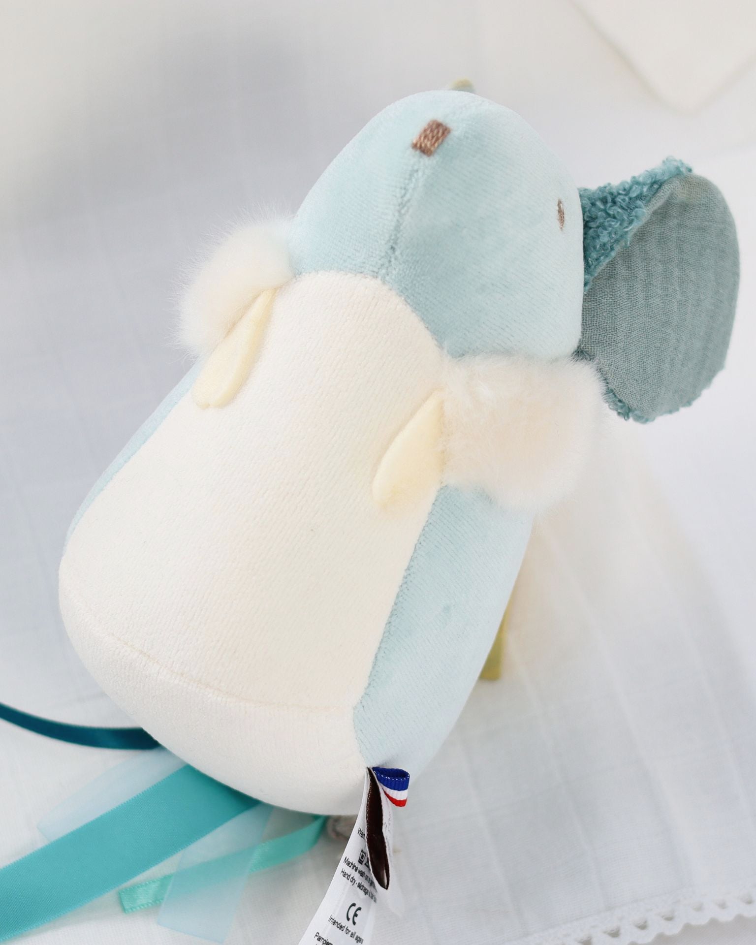 Plush toy with a label on a light background